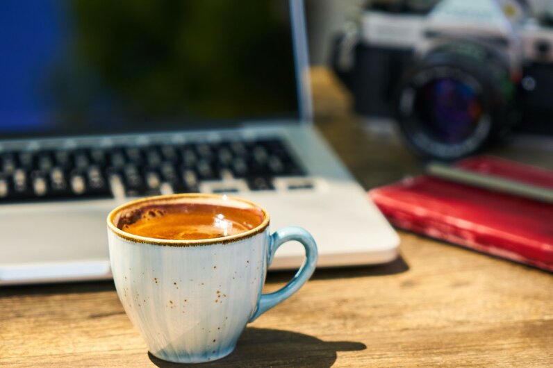 Coffee on laptop desk