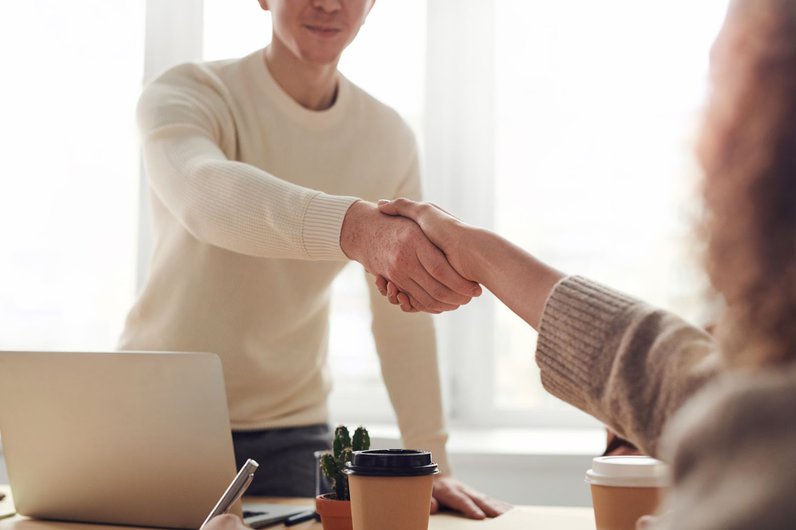 Shaking hands in business meeting
