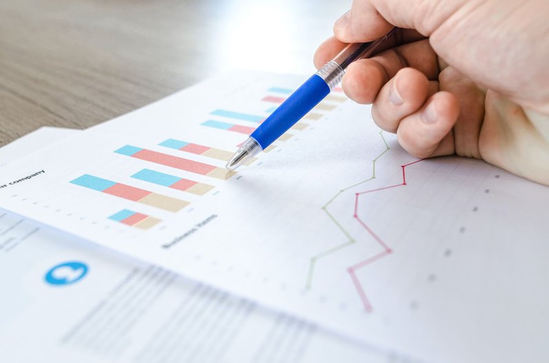 Looking over printed paper of website analytics